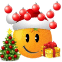 a smiley face wearing a santa hat and holding a christmas tree