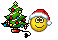 a smiley face next to a christmas tree