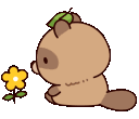 a brown teddy bear sitting next to a yellow flower
