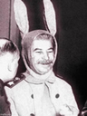 a man wearing a bunny ears hat next to another man