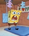 a spongebob is standing on a blue mat