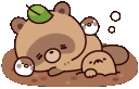 a brown bear laying on top of a pile of dirt