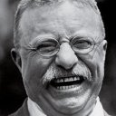 a black and white photo of a smiling man