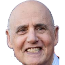 a man with a bald head wearing a suit and tie