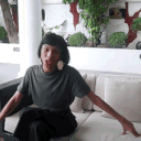 a person sitting on a couch with a laptop