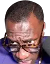 a man wearing glasses looking at a cell phone