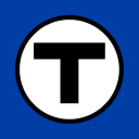 a blue and white sign with a black t in the middle