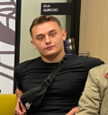two men sitting next to each other in a room