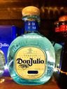 a bottle of tequila sitting on top of a wooden table