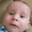 a blurry photo of a baby wearing a blue shirt