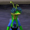 a green and blue alien standing on top of a sidewalk