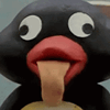 a close up of a black bird with its tongue out
