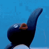 a close up of a penguin figurine with a blue background