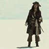 a man dressed in a pirate costume standing in the snow