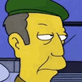 a man in a green hat looking at something