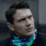a man in a black jacket and a green and blue tie