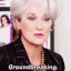 a woman with white hair and a black jacket