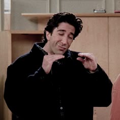 a man standing next to a woman in a kitchen
