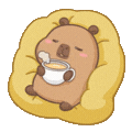 a brown bear sitting on top of a pillow holding a cup of coffee