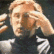a blurry image of a man holding his head