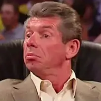 a man sitting in a chair with a surprised look on his face