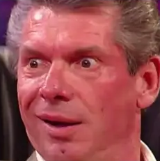 a close up of a person wearing a suit and tie