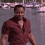 a man standing in front of a body of water