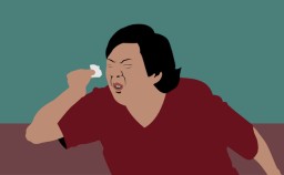 a man in a red shirt brushing his teeth