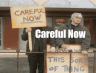 a couple of men standing next to each other holding signs
