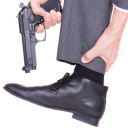 a man holding a gun in his right hand