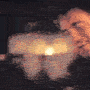 a blurry image of a teddy bear holding a lit candle