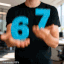 a man is holding a blue number in his hands