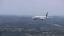 an airplane flying over a city on a foggy day