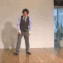 a man standing in front of a white wall