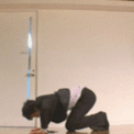 a man kneeling down on the floor in a room