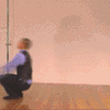 a blurry image of a man sitting on a wooden floor