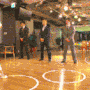 a group of men standing on top of a basketball court