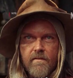 a man wearing a hat and a coat