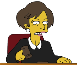 a woman sitting at a desk with a hammer in her hand